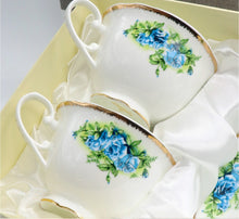 Load image into Gallery viewer, Tea cup and saucer set with floral design on a white background
