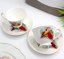 Load image into Gallery viewer, Teacup and saucer set with bird design on a white surface
